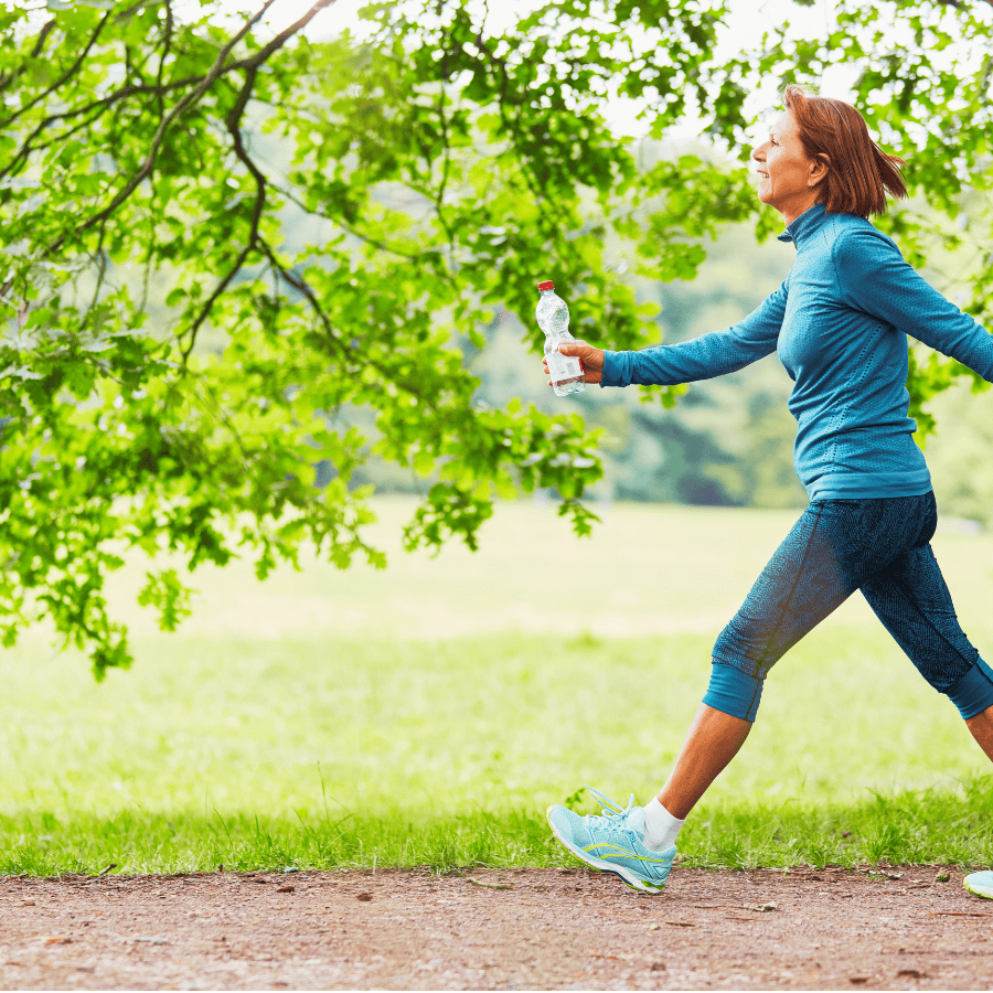 woman exercising outdoors celebrating self care, holistic mental health counseling orlando