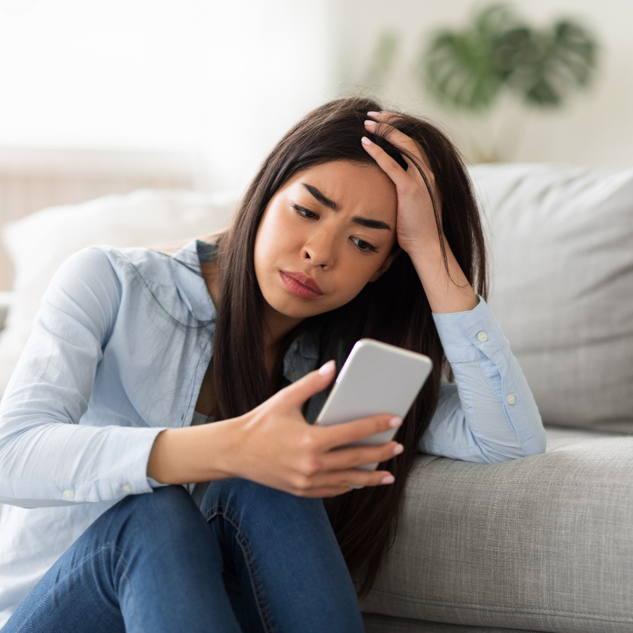 Confused woman reading social media feed with mental health-related posts, highlighting misinformation about anxiety therapy in Orlando