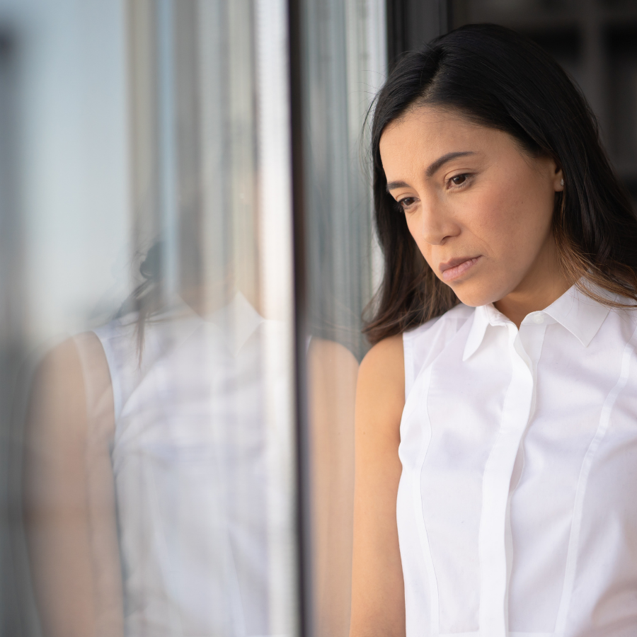 woman reflecting on church hurt looking out window.