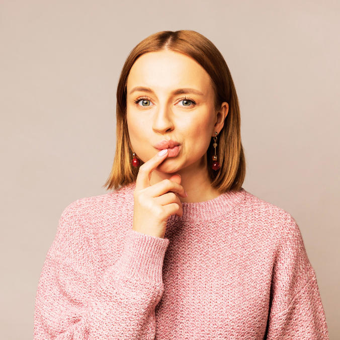 Woman looking uncertain with finger on pursed lips