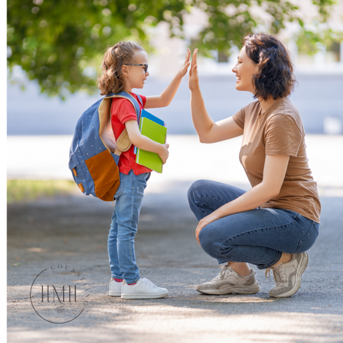 Mother high fiving young daughter that is wearing a book bag and holding books