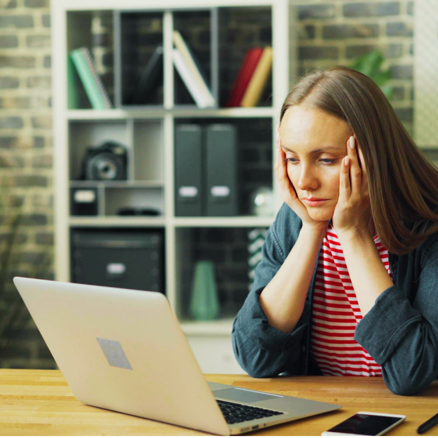 Young professional woman at her desk, managing anxiety with holistic mental health counseling in Orlando. 