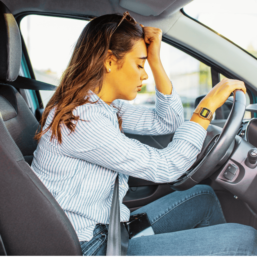 Stressed woman sitting in her car, reflecting on anxiety and seeking holistic mental health counseling in Orlando 